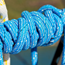 Close-up of blue rope tied to metal