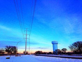 Electricity pylon on snow covered landscape