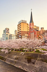 Buildings in city against clear sky