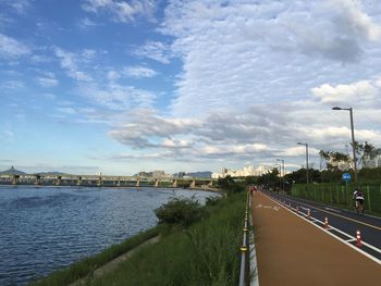 Road by city against sky