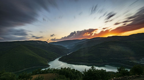 Scenic view of mountains against sky at sunset