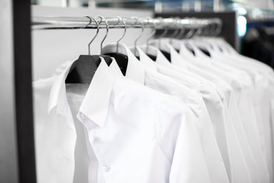 Close-up of clothes hanging on rack in store