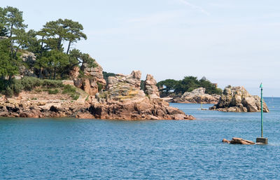 Scenic view of rock formation in sea against sky