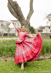 Low angle view of girl on field in park