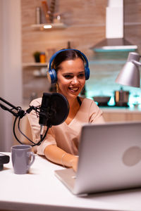 Portrait of young woman using digital tablet on table