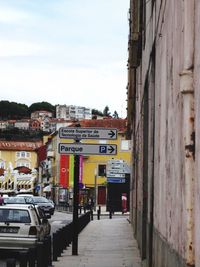 Road amidst city against sky