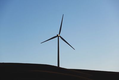 Low angle view of wind turbine against sky