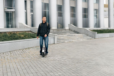 Man riding fast on electric unicycle on city street. mobile portable individual transportation