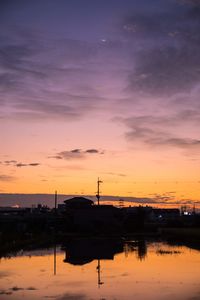 Scenic view of lake against orange sky