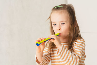 Child at home learning to play musical instruments. leisure and education at home. copy space