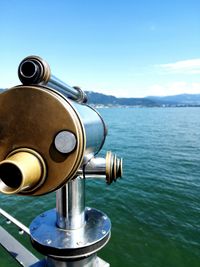 Close-up of coin-operated binoculars against sky