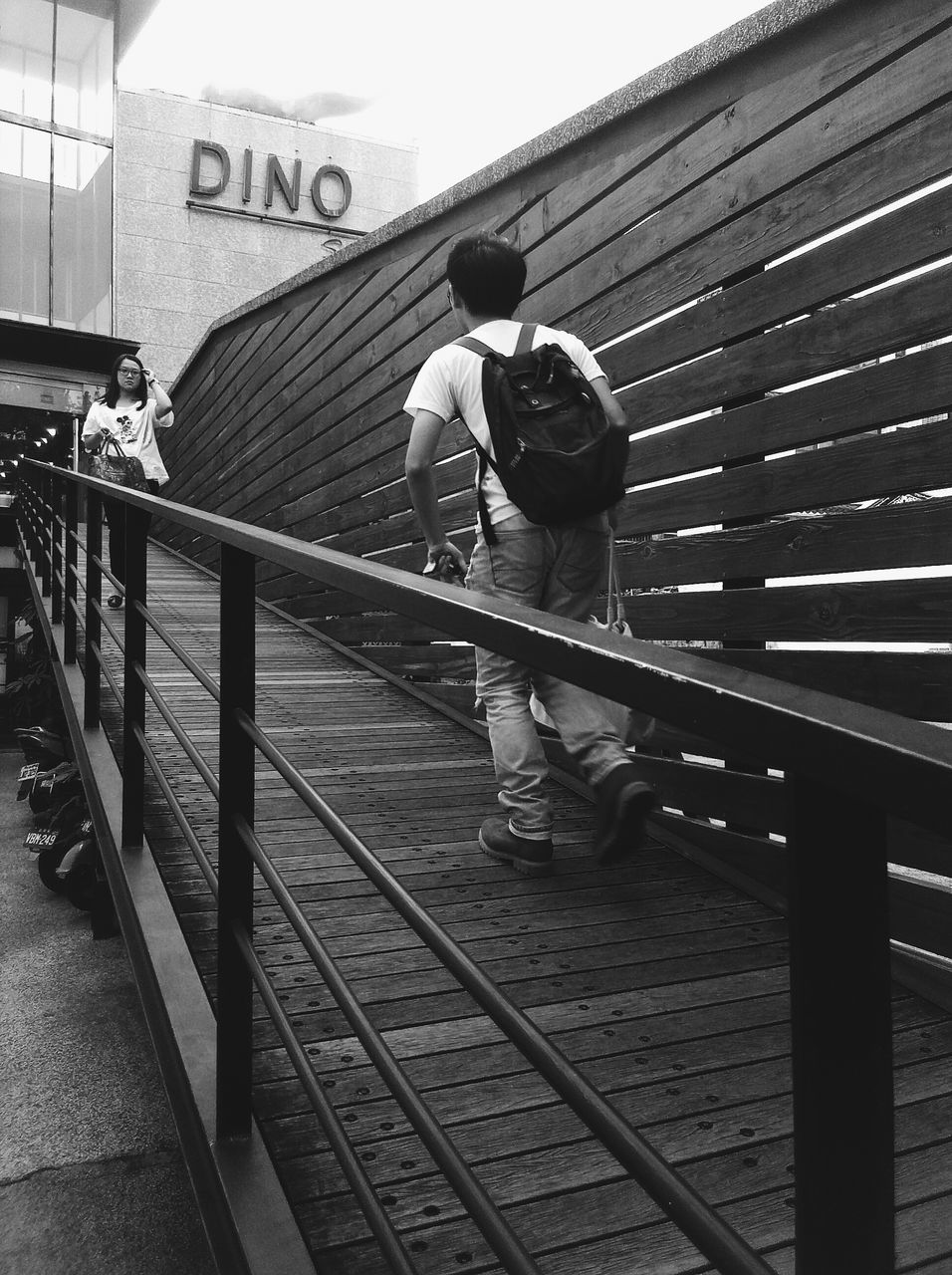 built structure, architecture, railing, building exterior, men, full length, day, low angle view, steps, sunlight, walking, outdoors, staircase, reflection, rear view, lifestyles, steps and staircases, building