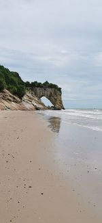 Scenic view of rocks on beach against sky