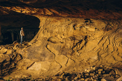 Man standing by rock formations