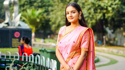 Portrait of smiling young woman standing outdoors