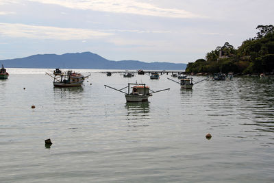 Boats in sea against sky