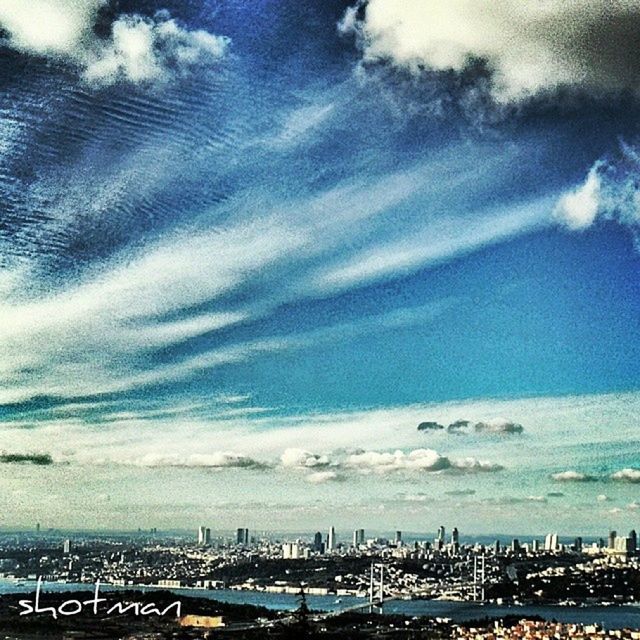 transportation, sea, mode of transport, sky, city, water, cloud - sky, built structure, cityscape, architecture, car, nautical vessel, building exterior, horizon over water, travel, high angle view, blue, cloudy, land vehicle, cloud