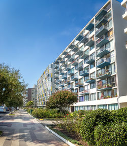 Low angle view of buildings against clear blue sky