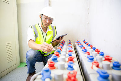 Man engineer in battery room in power plant for back up emergency case