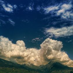 Scenic view of mountains against cloudy sky