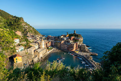 High angle view of sea and buildings against sky