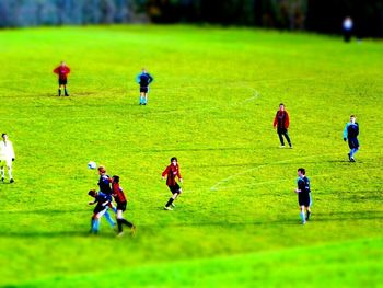 Man playing soccer on grassy field