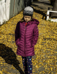 Portrait of woman with umbrella standing on cobblestone