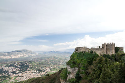 Aerial view of a medieval castle against cloudy sky