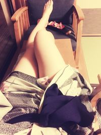 Low section of woman sitting on tiled floor