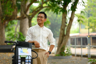 Portrait of young man standing in park