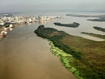 High angle view of sea and buildings against sky