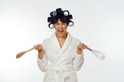 Portrait of smiling young woman against white background