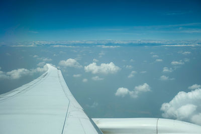 Aerial view of airplane flying in sky