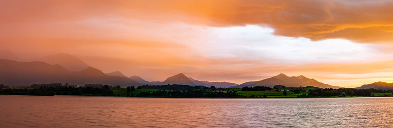 Scenic view of lake against orange sky