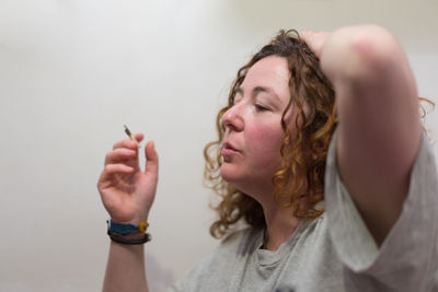 Portrait of young woman smoking cigarette