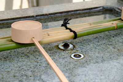 Wooden ladle on japanese drinking fountain