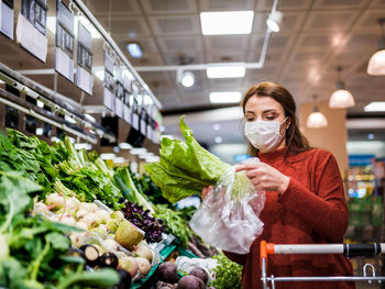 Woman holding ice cream in store