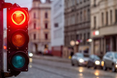 A city crossing with a semaphore, traffic light with red heart-shape in semaphore, valentine day 