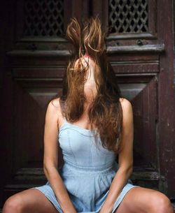 Rear view of woman in front of mannequin