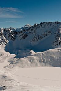 Scenic view of snow covered mountains against sky