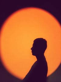 Portrait of silhouette man against orange sky