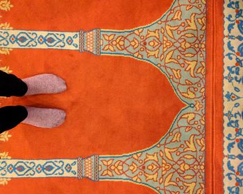 Low section of woman standing on tiled floor