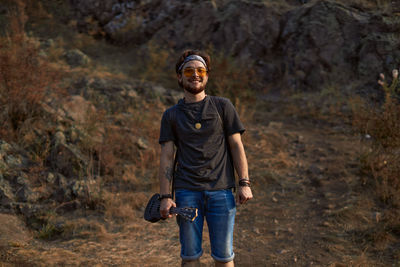 Portrait of a smiling young man in forest