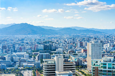 High angle view of buildings in city against sky