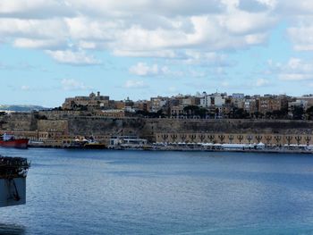 Town by sea against sky in city