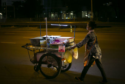 Side view of man riding bicycle on road