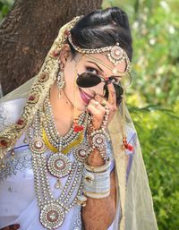 Portrait of bride wearing sunglasses