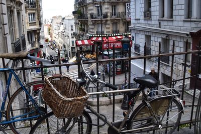 Bicycles parked by railing in city