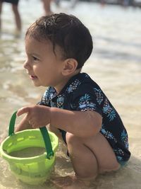 Cute boy playing at the beach 