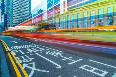 Light trails on street against buildings in city